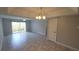 Bright living room with tile floors, ceiling fan, sliding glass doors leading to the backyard at 7502 Bolanos Ct, Tampa, FL 33615