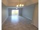 Open living room with tile flooring, ceiling fan, and sliding door to the exterior at 7502 Bolanos Ct, Tampa, FL 33615