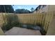 Back patio with a yellow wooden fence and partial views of the building at 7502 Bolanos Ct, Tampa, FL 33615
