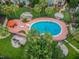 Aerial view of the community pool with mature trees and a fence surrounding the perimeter at 7512 Dolonita Dr # 7512, Tampa, FL 33615