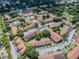 Birds-eye view of the community including a tennis court, community pool, yellow buildings and parking at 7512 Dolonita Dr # 7512, Tampa, FL 33615