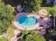 Aerial view of the community pool with a kidney bean shape surrounded by lounge areas and palm trees at 7512 Dolonita Dr # 7512, Tampa, FL 33615