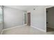 Bright bedroom with sleek tiled floor, fresh light-grey paint, and a frosted glass-door closet at 7512 Dolonita Dr # 7512, Tampa, FL 33615