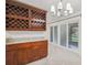 A dining room with tiled floors, a wine rack, breakfast bar, and sliding glass doors to the patio at 7512 Dolonita Dr # 7512, Tampa, FL 33615