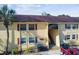 Charming two-story condo with red shutters, palm tree, covered stairwell, and ample parking at 7512 Dolonita Dr # 7512, Tampa, FL 33615