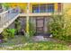Exterior ground floor entrance and stairway surrounded by natural foliage at 7512 Dolonita Dr # 7512, Tampa, FL 33615
