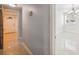 Hallway that leads to multiple rooms with tile flooring and modern lighting, creating a cohesive flow at 7512 Dolonita Dr # 7512, Tampa, FL 33615