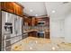 This kitchen has stainless steel appliances, granite countertops and brown wood cabinets at 7512 Dolonita Dr # 7512, Tampa, FL 33615