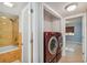 View of the bathroom and laundry room featuring modern washer and dryer units, tile flooring and glass shower at 7512 Dolonita Dr # 7512, Tampa, FL 33615