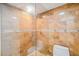 Luxurious tiled shower with glass doors, offering a spa-like experience and modern design at 7512 Dolonita Dr # 7512, Tampa, FL 33615