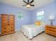 Bedroom with blue walls, natural light, ceiling fan and wood furniture at 7755 39Th N Ave, St Petersburg, FL 33709