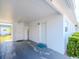 A well-lit carport featuring an entryway door and storage, providing convenient access and additional space at 7755 39Th N Ave, St Petersburg, FL 33709