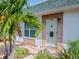 Inviting entrance featuring a stylish front door and vibrant landscaping at 7755 39Th N Ave, St Petersburg, FL 33709