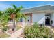 Charming single-story home with a well-manicured front yard and lush tropical landscaping at 7755 39Th N Ave, St Petersburg, FL 33709