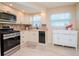 Bright kitchen with modern appliances, white cabinetry, and stylish backsplash at 7755 39Th N Ave, St Petersburg, FL 33709