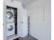 Laundry room featuring a stacked washer and dryer set and storage at 7755 39Th N Ave, St Petersburg, FL 33709