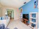 Living room showing a white sofa, blue accent wall, and view into an office at 7755 39Th N Ave, St Petersburg, FL 33709
