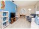 Comfortable living room featuring a white sofa, blue accent wall, and casual decor at 7755 39Th N Ave, St Petersburg, FL 33709