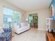 Bright living room featuring a large window and comfortable seating area with a peek into the office at 7755 39Th N Ave, St Petersburg, FL 33709