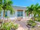 Outdoor patio area with seating, lush plants, and tropical palm trees providing a peaceful and private space at 7755 39Th N Ave, St Petersburg, FL 33709