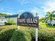 Community sign that reads Tyrone Villas, a 55+ community, with nearby landscaping and palm trees at 7755 39Th N Ave, St Petersburg, FL 33709