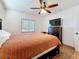 Comfortable bedroom featuring a ceiling fan, window, and a spacious wooden dresser with a television at 777 62Nd N Ave, St Petersburg, FL 33702