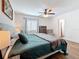 Bedroom featuring wood-look floors, a ceiling fan, and an ensuite bathroom at 777 62Nd N Ave, St Petersburg, FL 33702