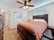 Spacious bedroom featuring wood-look flooring and a full-sized bed with stylish, dark wood frame at 777 62Nd N Ave, St Petersburg, FL 33702