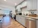 Updated kitchen features stainless steel appliances, gray cabinets, granite counters, and modern backsplash at 777 62Nd N Ave, St Petersburg, FL 33702