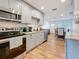 Bright kitchen boasts stainless appliances, granite countertops, gray cabinets, and a modern backsplash at 777 62Nd N Ave, St Petersburg, FL 33702