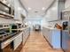 Galley kitchen boasts stainless appliances, granite counters, shaker cabinets, and hardwood floors at 777 62Nd N Ave, St Petersburg, FL 33702