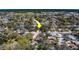 Aerial photo highlighting a property's location within a leafy community, indicated by a directional arrow for emphasis at 8740 Forest Lake Dr, Port Richey, FL 34668
