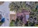 Aerial view of the property showing the roof, driveway, and tree coverage of a single-Gathering home at 8740 Forest Lake Dr, Port Richey, FL 34668
