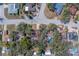 An aerial view shows the property is surrounded by mature trees in a well-established neighborhood at 8740 Forest Lake Dr, Port Richey, FL 34668