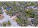Aerial view of a residential area with homes surrounded by mature trees, offering shade and privacy at 8740 Forest Lake Dr, Port Richey, FL 34668
