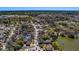 Aerial shot showcasing a neighborhood location close to a lake with lush green landscaping, featuring mature trees throughout the community at 8740 Forest Lake Dr, Port Richey, FL 34668