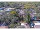 Wide aerial view of a neighborhood featuring mature trees, showcasing a single-Gathering home nestled among residences at 8740 Forest Lake Dr, Port Richey, FL 34668