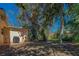 Spacious and shaded back yard with large mature trees and patio with grill at 8740 Forest Lake Dr, Port Richey, FL 34668