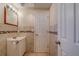 Bathroom features a vanity, decorative tile accent and a toilet at 8740 Forest Lake Dr, Port Richey, FL 34668