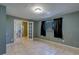 Bedroom featuring tile flooring and french doors to an additional room at 8740 Forest Lake Dr, Port Richey, FL 34668