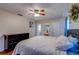 A light and airy bedroom includes a ceiling fan, access to an ensuite bathroom, and neutral color scheme at 8740 Forest Lake Dr, Port Richey, FL 34668