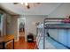 Bedroom featuring wood flooring, bunk beds, a ceiling fan, and walk-in closet at 8740 Forest Lake Dr, Port Richey, FL 34668
