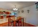 Cozy dining area with a wooden table and chairs, pendant lighting, and adjacent view to kitchen area at 8740 Forest Lake Dr, Port Richey, FL 34668