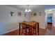 Dining area featuring a wooden table set, hardwood floors, and a view into another room at 8740 Forest Lake Dr, Port Richey, FL 34668