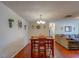 Dining room area with a wooden table set, hardwood floors, and decorative wall accents at 8740 Forest Lake Dr, Port Richey, FL 34668