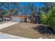 Well maintained single story home with mature trees and an attached two car garage and nice landscaping at 8740 Forest Lake Dr, Port Richey, FL 34668