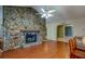 A large fireplace made of light colored stone in the living room at 8740 Forest Lake Dr, Port Richey, FL 34668