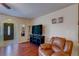 Comfortable living room showcasing hardwood floors, a ceiling fan, and a cozy leather recliner at 8740 Forest Lake Dr, Port Richey, FL 34668