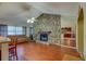 Living room featuring stone fireplace and hardwood floors, creating a warm and inviting atmosphere at 8740 Forest Lake Dr, Port Richey, FL 34668