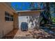 Patio with red brick pavers, covered grill, and small table with chairs at 8740 Forest Lake Dr, Port Richey, FL 34668